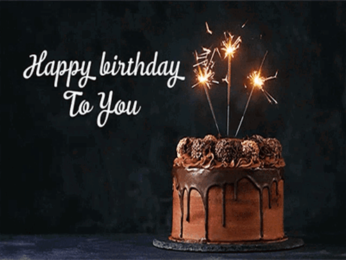 A Chocolate Birthday Cake With Sparklers On Top And The Words Happy Birthday To You Below It GIF