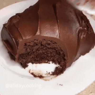 A Chocolate Cake With A Bite Taken Out Of It GIF
