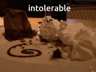 A Chocolate Dessert With Whipped Cream And Chocolate Sauce With The Word Intolerable Written Above It GIF
