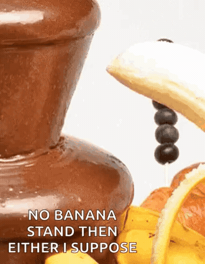 A Chocolate Fountain With A Banana And Blueberries On Top Of It . GIF