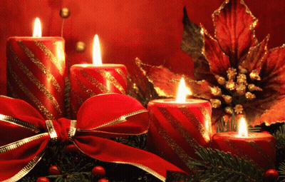 A Christmas Decoration With Candles And A Bow GIF