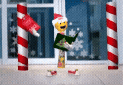 A Christmas Elf Is Holding A Book And A Tube Of Toothpaste . GIF