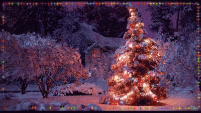 A Christmas Tree Is Lit Up In Front Of A Snowy House GIF