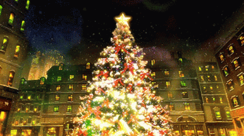 a christmas tree with a star on top is lit up in a city at night