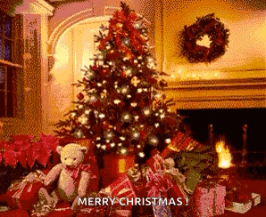 A Christmas Tree With Gifts Underneath It And A Teddy Bear In Front Of It . GIF