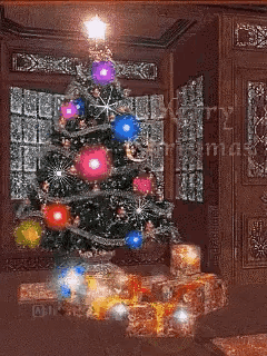 A Christmas Tree With Gifts Underneath It And The Words Merry Christmas On The Bottom GIF