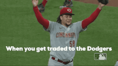 A Cincinnati Baseball Player Is Holding His Arms In The Air GIF