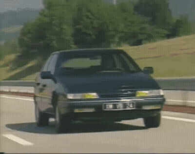 A Citroen Car Is Driving Down A Highway With A License Plate That Says Jm T14 GIF