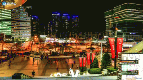 A City At Night With A Sign That Says ' New V ' On It GIF