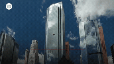 A City Skyline With A Country Living Logo On The Bottom Right GIF