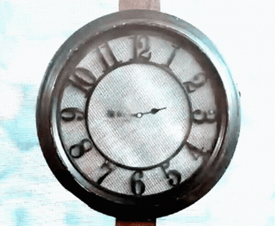 A Clock That Has The Hands On The Numbers 1 And 12 GIF