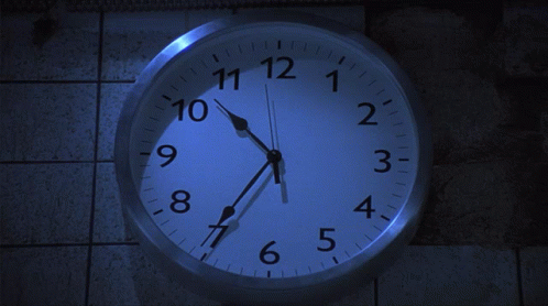 A Clock That Has The Hands On The Numbers 1 And 12 GIF