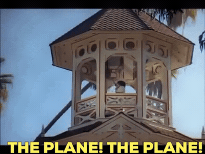 A Clock Tower With The Words " The Plane The Plane " Above It GIF