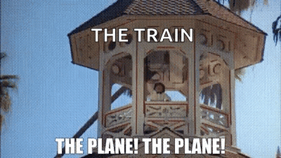 A Clock Tower With The Words `` The Train The Plane ! The Plane ! '' Written On It . GIF
