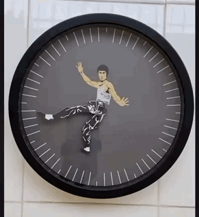 A Clock With A Picture Of Bruce Lee In The Center GIF