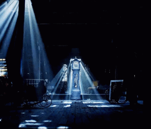 A Clock With Roman Numerals On The Face Is Surrounded By Red Lights GIF