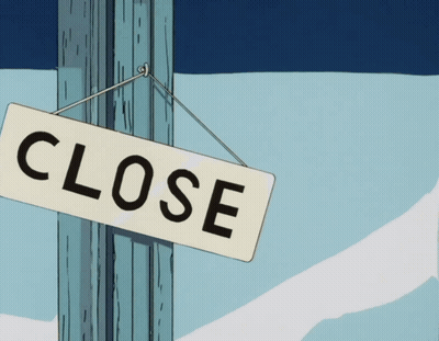 A Close Sign Is Hanging On A Pole In The Snow GIF