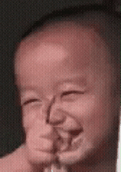 A Close Up Of A Baby Making A Funny Face GIF