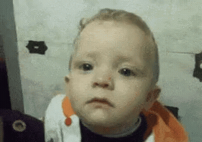 A Close Up Of A Baby Making A Sad Face . GIF