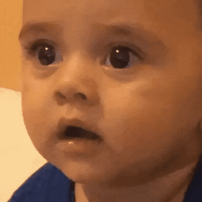 A Close Up Of A Baby Making A Surprised Face GIF
