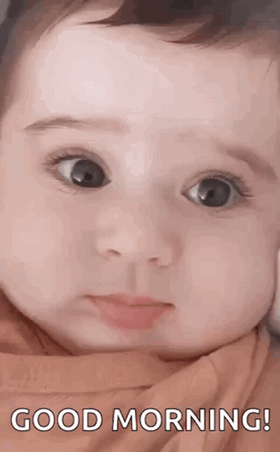 A Close Up Of A Baby 'S Face With The Words `` Good Morning '' Written Above It . GIF