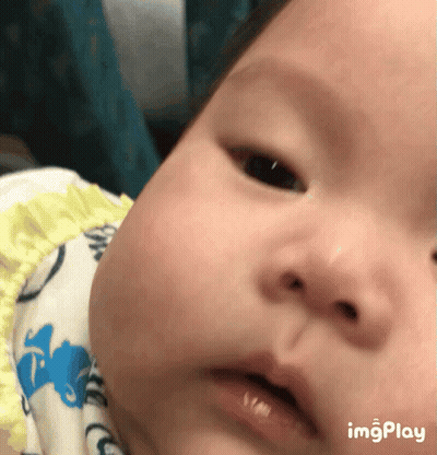 A Close Up Of A Baby 'S Face With The Words Imgplay Below GIF