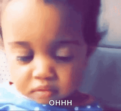 A Close Up Of A Baby 'S Face With The Words Ohhh Written On The Bottom GIF