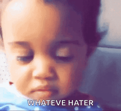 A Close Up Of A Baby 'S Face With The Words " Whateve Hater " Written Below It GIF
