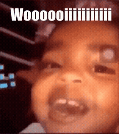 A Close Up Of A Baby 'S Face With The Words " Woooo " Written Above It GIF