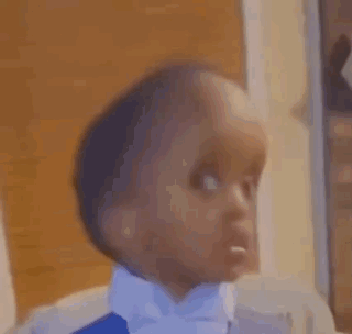 A Close Up Of A Baby Wearing A Bow Tie And Making A Funny Face . GIF