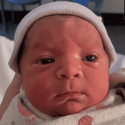 A Close Up Of A Baby Wearing A Hat GIF