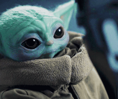 A Close Up Of A Baby Yoda In A Jacket GIF