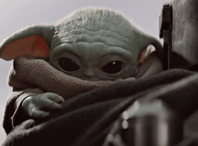 A Close Up Of A Baby Yoda Looking Up GIF