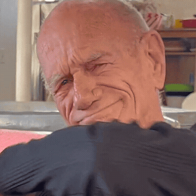 A Close Up Of A Bald Man 'S Face With A Black Shirt On GIF