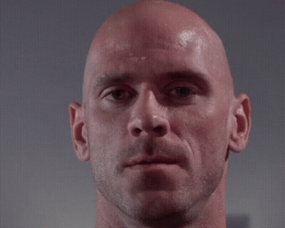 A Close Up Of A Bald Man 'S Face With A Hand Touching His Forehead GIF