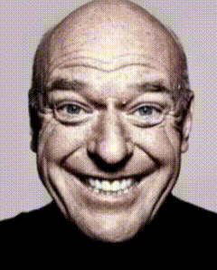 A Close Up Of A Bald Man Smiling With A Black Shirt On GIF