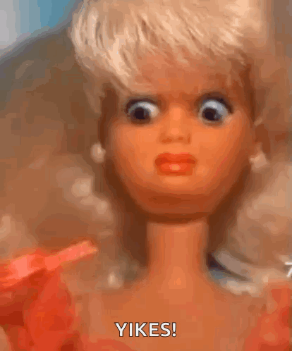 A Close Up Of A Barbie Doll Making A Funny Face And Saying Yikes GIF