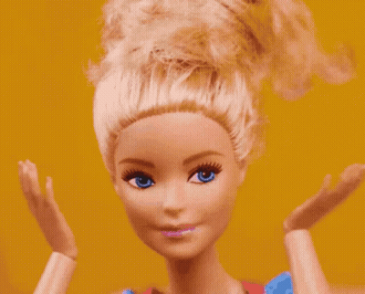 A Close Up Of A Barbie Doll 'S Face With Blue Eyes GIF