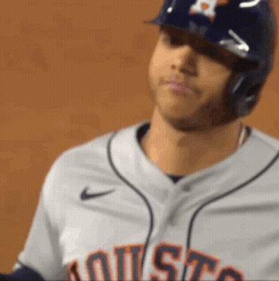 A Close Up Of A Baseball Player Wearing A Helmet And A Jersey That Says Houston GIF