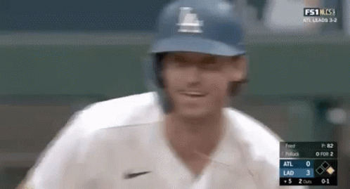 A Close Up Of A Baseball Player Wearing A Helmet And A White Jersey . GIF