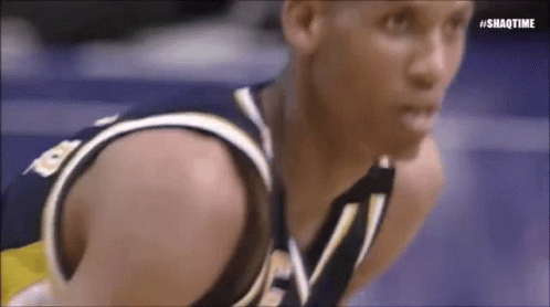 A Close Up Of A Basketball Player Kneeling On The Court . GIF