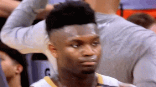 A Close Up Of A Basketball Player Looking At The Camera . GIF