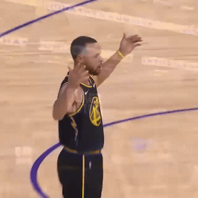 A Close Up Of A Basketball Player With His Fist In The Air . GIF