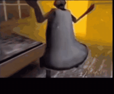 A Close Up Of A Bell With A Person Standing Behind It GIF