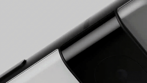 A Close Up Of A Black Cell Phone On A White Surface . GIF