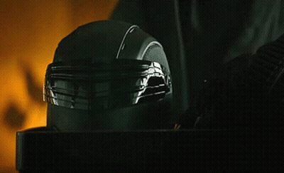 A Close Up Of A Black Helmet On A Table With A Yellow Background GIF