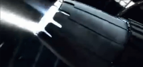 A Close Up Of A Black Object In A Dark Room With A Light Coming Out Of It . GIF