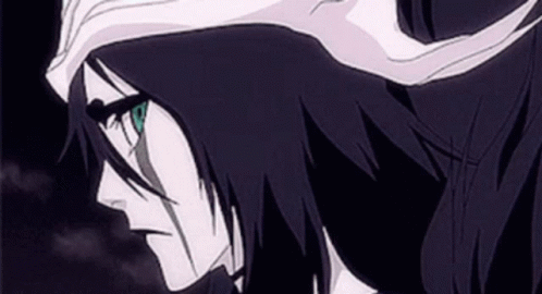 A Close Up Of A Bleach Character With Long Black Hair And Green Eyes GIF