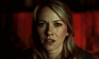 A Close Up Of A Blonde Woman 'S Face With A Red Background GIF
