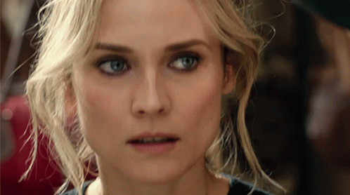 A Close Up Of A Blonde Woman 'S Face With Blue Eyes GIF